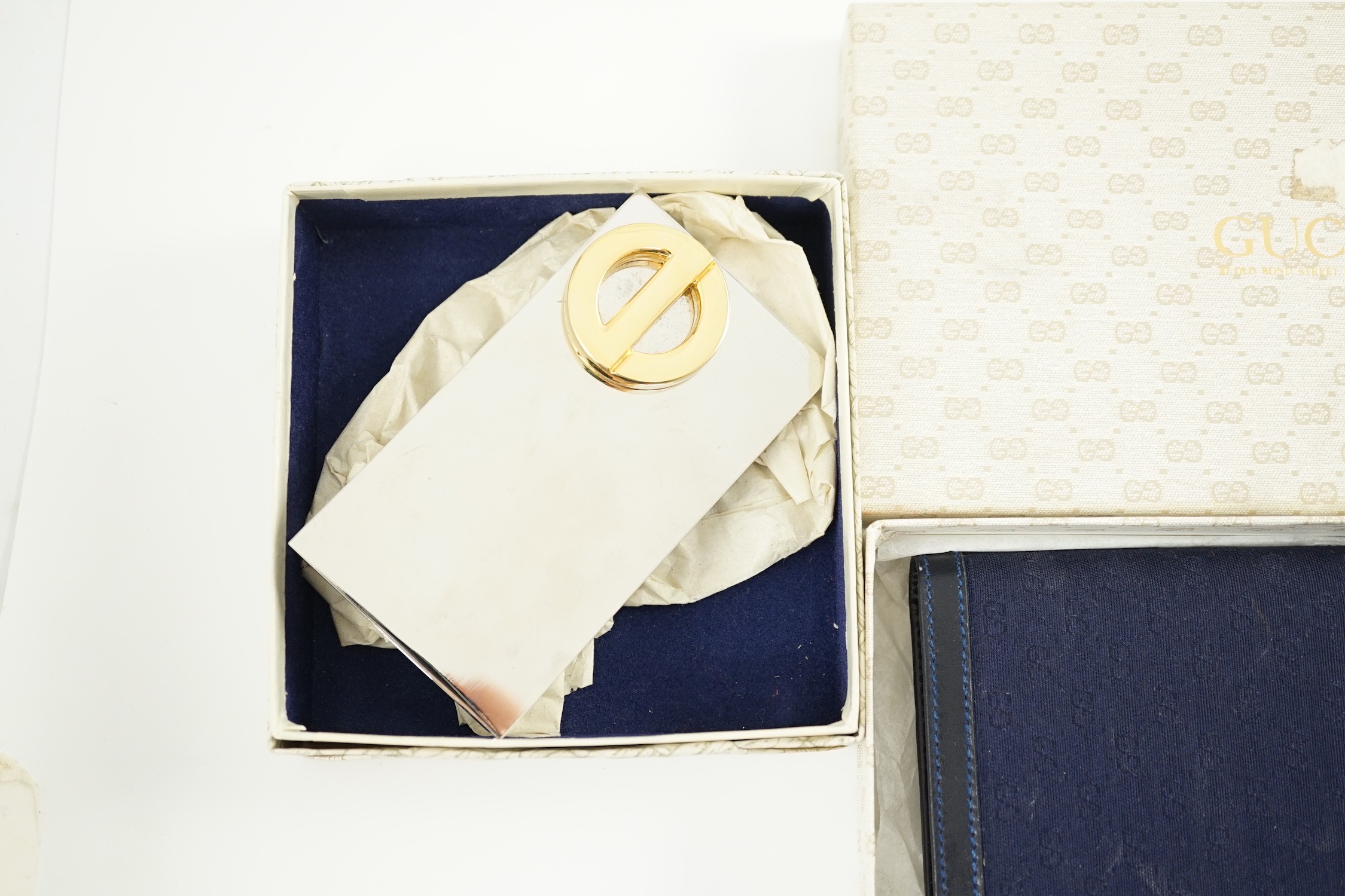 A Gucci blue leather address book, a Smythson leather travel wallet and a Christian Dior desk clip, all boxed.